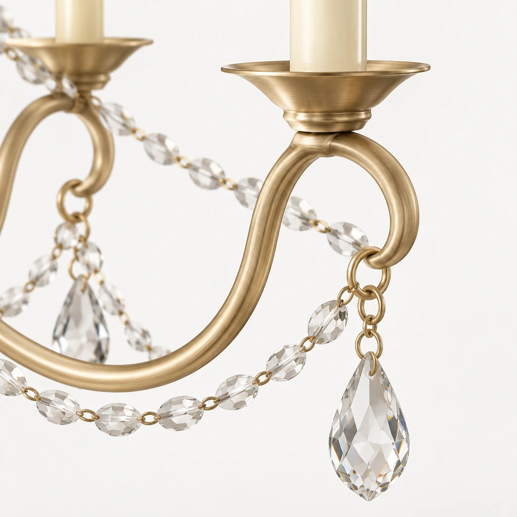 Close detail of the champagne-gold arm and clear crystal drop