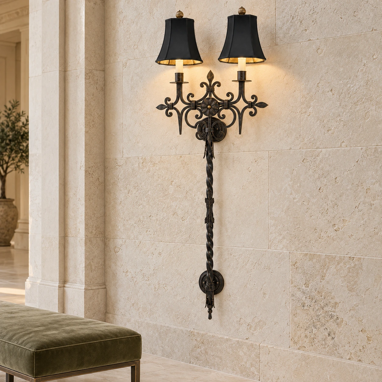 Black distressed iron wall sconce on a pale stone hospitality wall