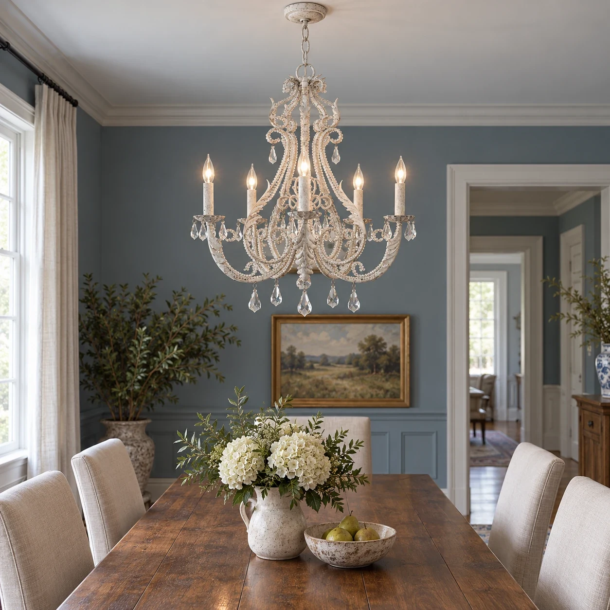 Five-light Camille chandelier over a dining table in a blue-gray American dining room