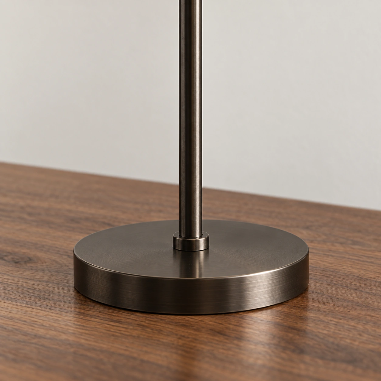 Close-up of the metal stem and round disk base