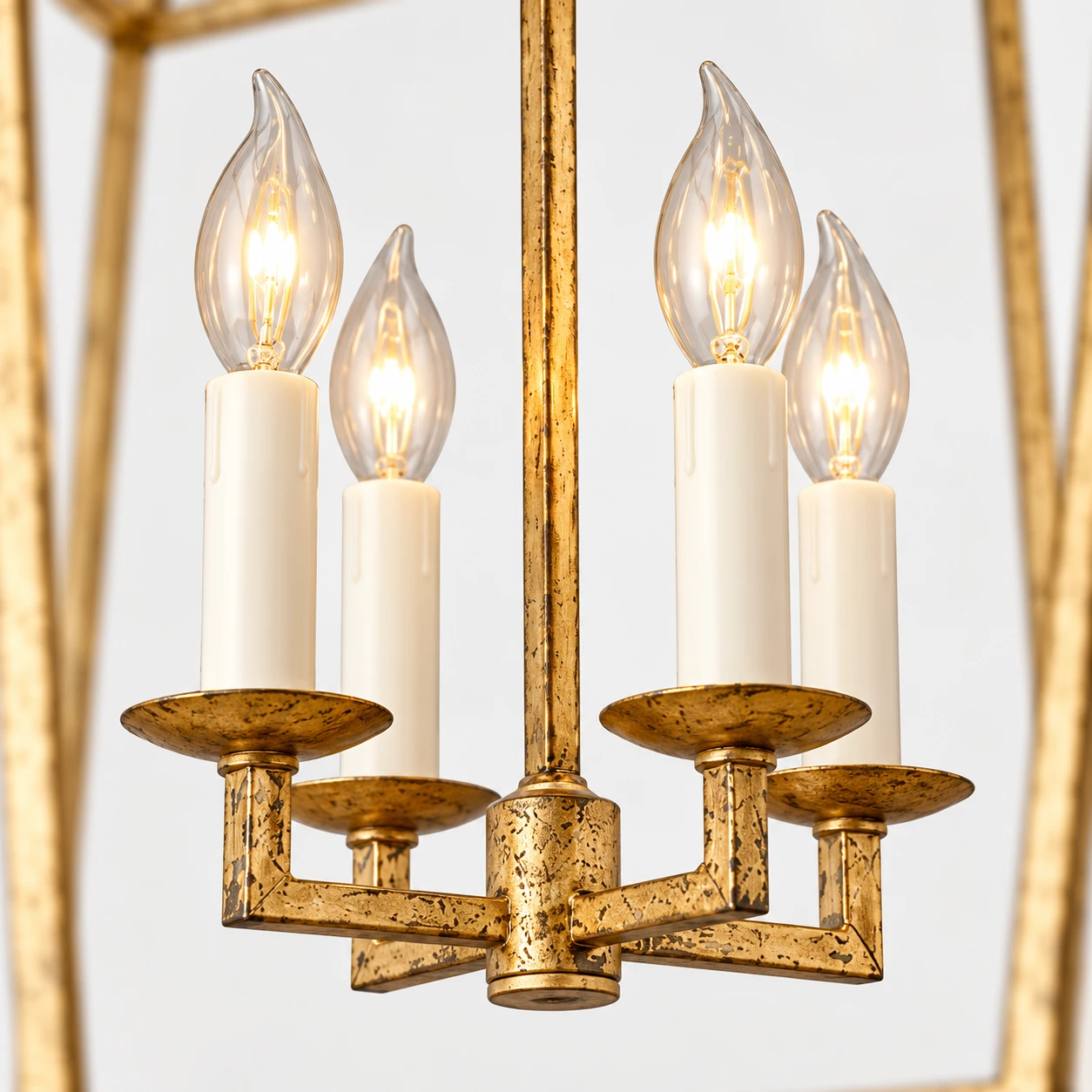 Four candle-style bulbs of the Nora Vintage Caged Iron Chandelier